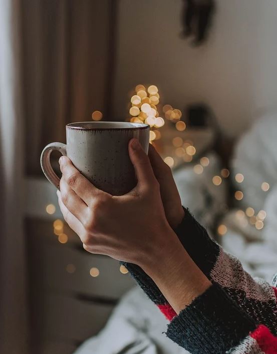 hands holding a mug